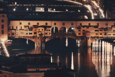 Ponte Vecchio gece Floransa 'da Arno Nehri üzerinde.