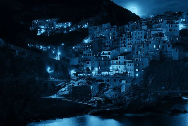 Manarolaは地中海と月の上昇を見過ごすことができ イタリアの夜にはCinque Terreの崖の上に建物があります — ストック写真