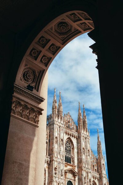 Milan Cathedral viewed through archway in Italy. 