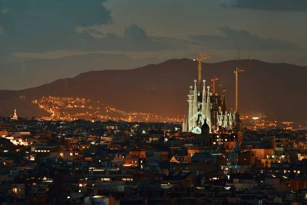 スペインのバルセロナで夜の都市スカイラインを持つサグラダ ファミリア — ストック写真