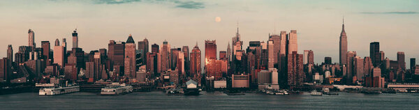 Moon rise over midtown Manhattan with city skyline at sunset