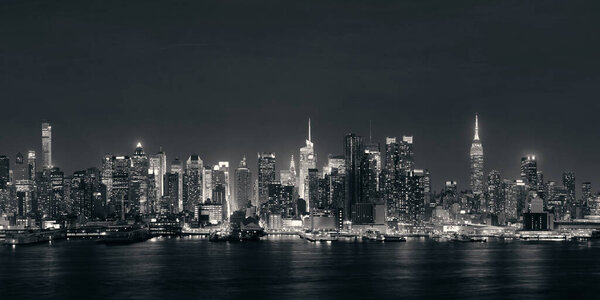 Midtown skyline over Hudson River panorama in New York City with skyscrapers at night