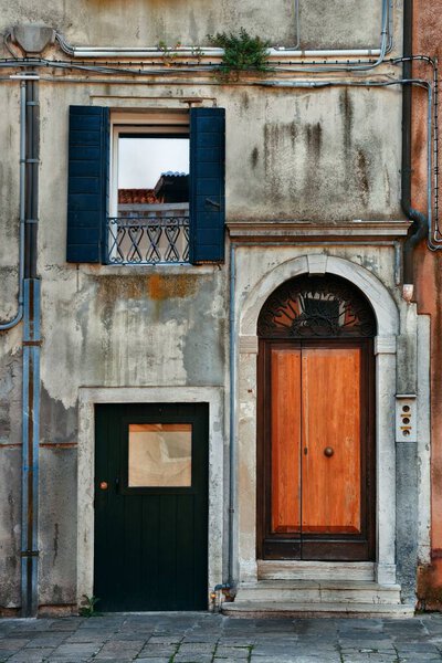 Vintage door and window in old buildings in Venice, Italy.