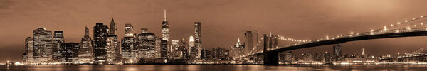 Manhattan Downtown urban view with Brooklyn bridge at night