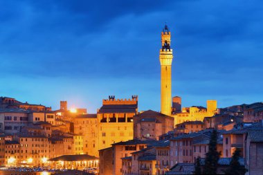 Ortaçağ şehri Siena manzarası görünümüyle çan kulesi ve İtalya tarihi binaları geceleri