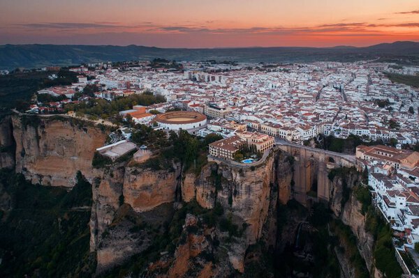 Ronda aerial view at sunrise with old buildings in Spain.