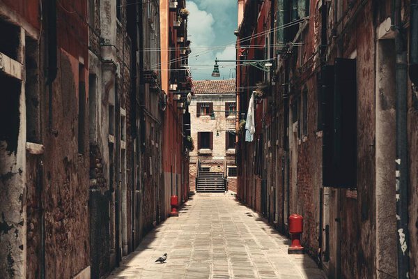Alley view with historical buildings in Venice, Italy.