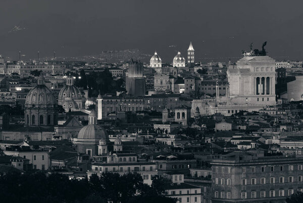 Rome rooftop view with ancient architecture in Italy at night in black and white.