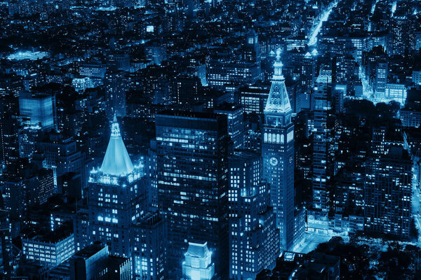 New York City historical skyscrapers and urban cityscape at night.