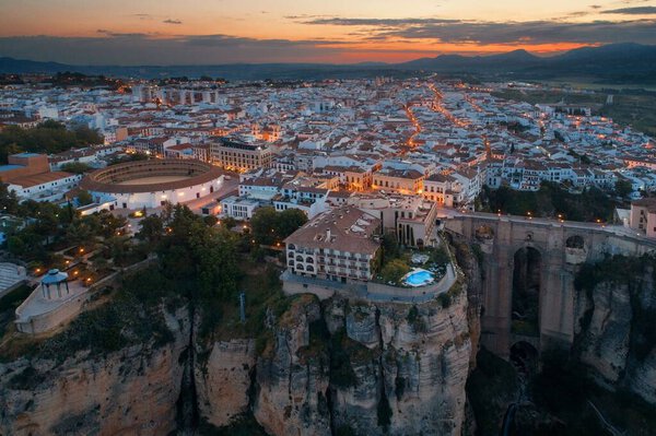 Ronda aerial view with old buildings at night in Spain.