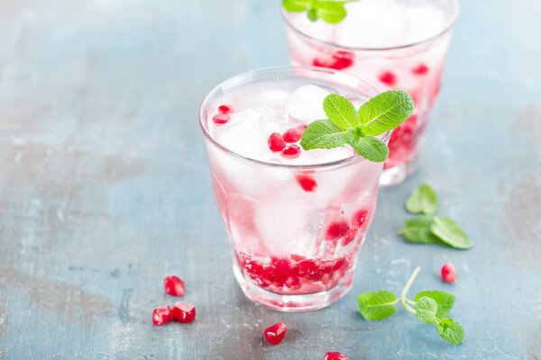Infused water made of fresh pomegranate and mineral water with ice