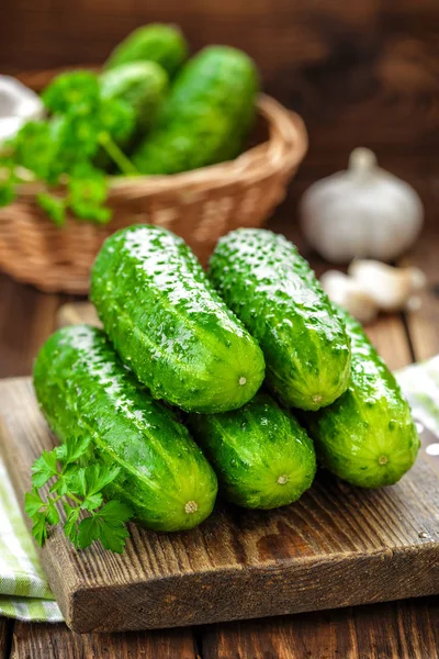 Fresh cucumbers on wooden background — Stock Photo, Image