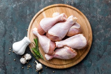 Çiğ çiğ tavuk budu, sopaları ahşap masa, etli yemek, maddeler üzerinde görünümü top