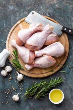 Çiğ çiğ tavuk budu, sopaları ahşap masa, etli yemek, maddeler üzerinde görünümü top