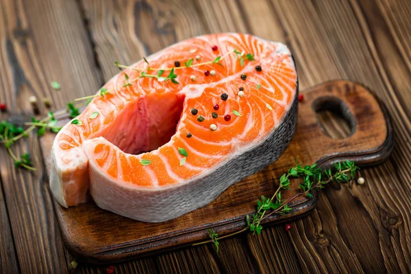 Salmon fish steak on wooden background — Stock Photo, Image