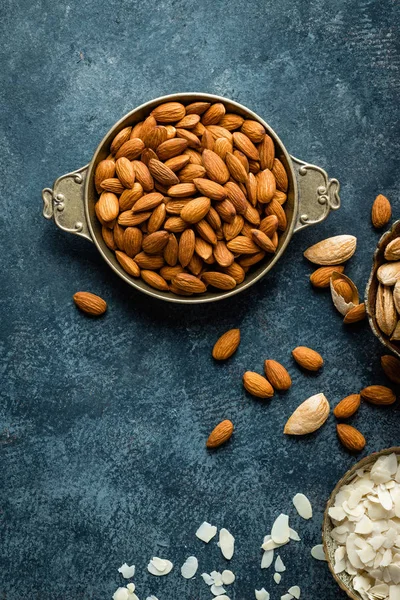 Almond nuts on dark background directly above copy space flat lay — Stock Photo, Image