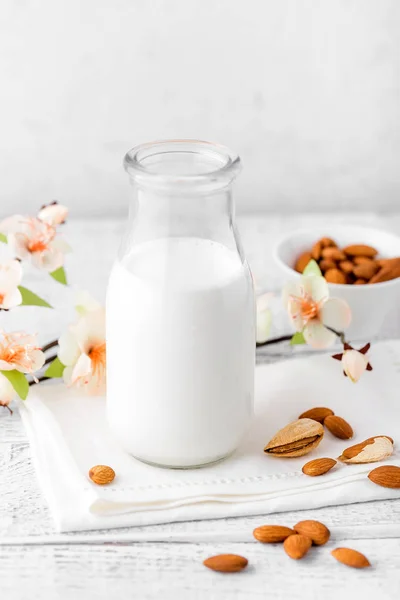 Almond nuts and milk on white background