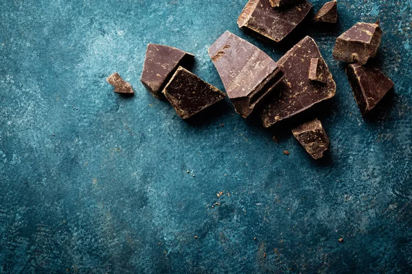 Dark chocolate pieces crushed on a dark background