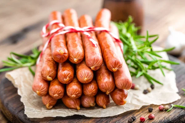 Sausages on wooden background — Stock Photo, Image