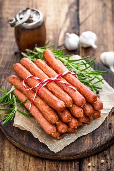 Sausages on wooden background — Stock Photo, Image