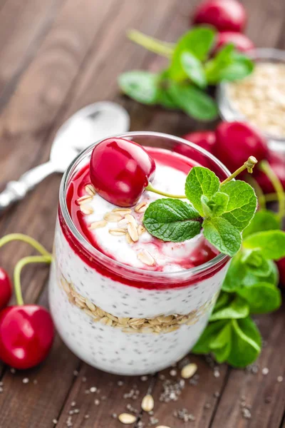 Fresh cherry yogurt with oats and chia seeds, delicious dessert for healthy breakfast