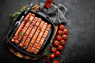 Izgara sosis sosisleri tavada kızartma kızartma-siyah arka plan üzerine. Üstten Görünüm. Geleneksel Alman yemekleri. Stok görüntü