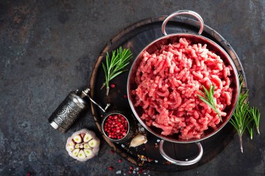 Kıymalı yemek. Çiğ Dana kıyma malzemelerle siyah mutfak masasında yemek pişirmek için. Taze kıyılmış et, üstten görünüm
