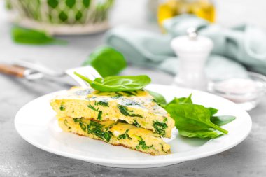Ispanak yapraklı omlet. Tabakta omlet, çırpılmış yumurta.