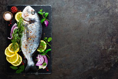 Taze dorado balık. Çiğ dorado balık ve gemide yemek pişirmek için madde. Çipura veya dorada balık Mutfak masasında