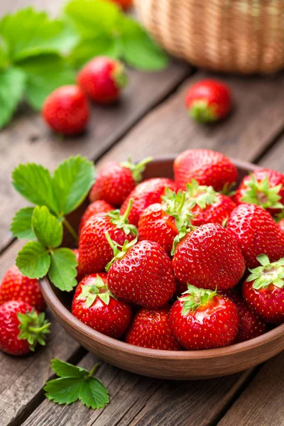 Strawberry. Fresh strawberry with leaves on wooden table