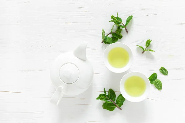 Green Mint Tea Fresh Leaves Cups Teapot Overhead White Wooden — Stock Photo, Image