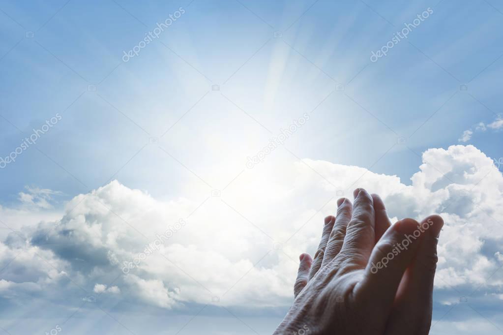 Prayer hands in sky