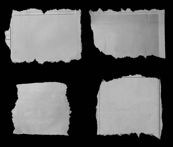 Порванные бумаги о черном — стоковое фото