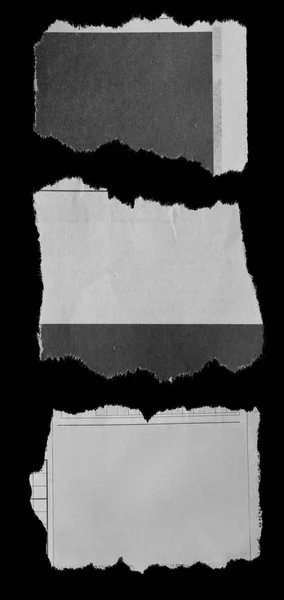 Torn papers on black — Stock Photo, Image