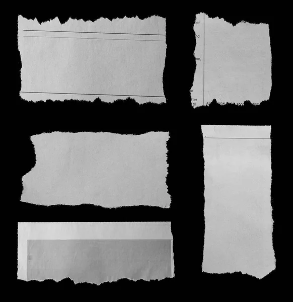 Torn papers on black — Stock Photo, Image