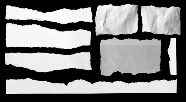 Torn papers on black — Stock Photo, Image