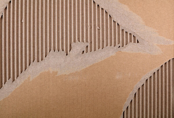 Closeup of torn brown cardboard texture 