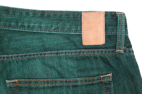 Leather label on green jeans. — Stock Photo, Image