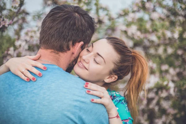 Loving couple in blossom garden — Stock Photo, Image