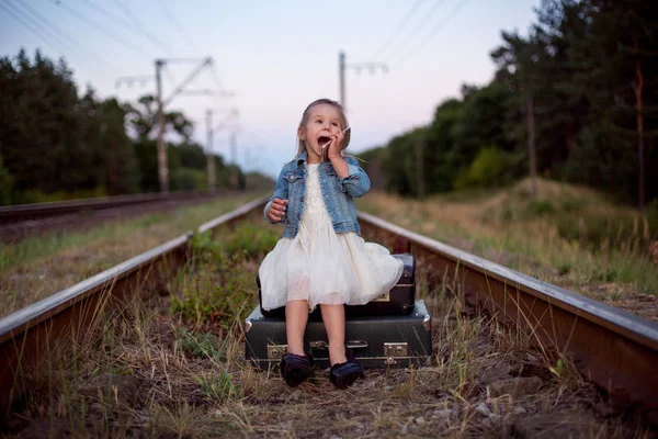 Маленька дівчинка сидить на багажі — стокове фото