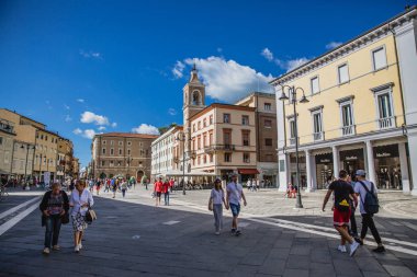 Historical architecture and people on street of Rimini city, Italy clipart
