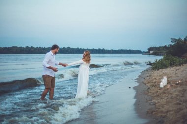 Yakışıklı delikanlı ve onun hamile eşi eğleniyor nehirde yaz akşamları