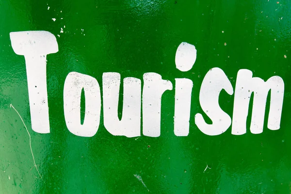 Tourism text against green background — Stock Photo, Image