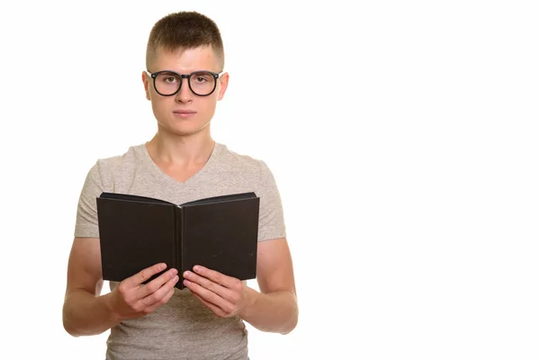 Young Caucasian man holding book — Stock Photo, Image