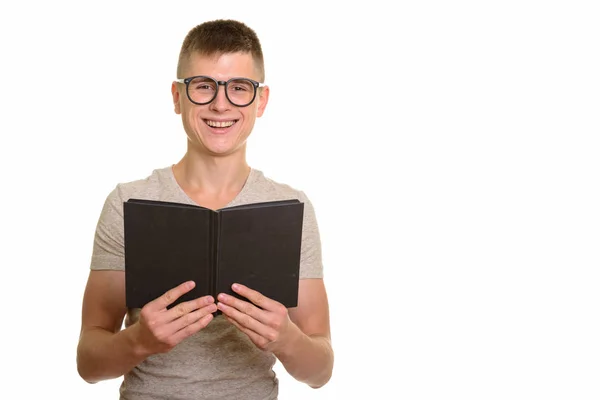 Young happy Caucasian man smiling and holding book — Stock Photo, Image