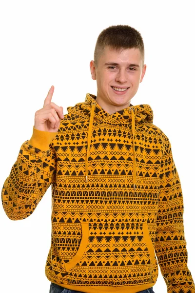 Young happy Caucasian man smiling and pointing finger up — Stock Photo, Image