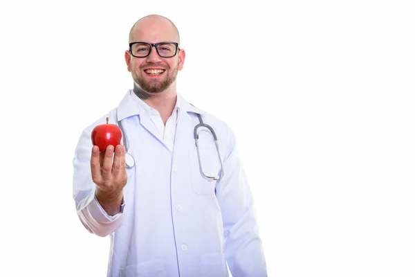 Stüdyoda Elinde Kırmızı Elmayla Gülümseyen Kel Kaslı Bir Adamın Fotoğrafı — Stok fotoğraf