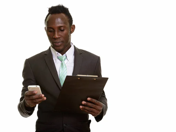 Young Black African Businessman Using Mobile Phone While Holding Clipboard — Stock Photo, Image