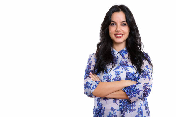 Studio shot of young happy Spanish businesswoman smiling with arms crossed