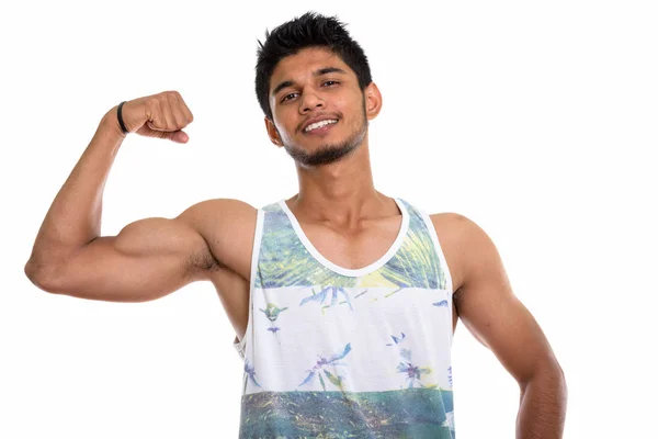 腕を曲げポーズをしながら笑顔若い幸せなインド人の男のスタジオショット — ストック写真